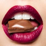 Beautiful female lips with chocolate